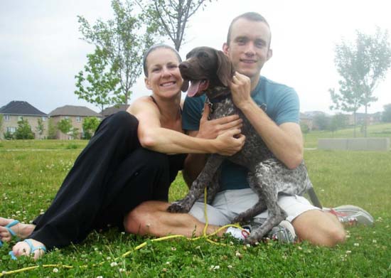 A Fogelhund GSP cuddles with family.
